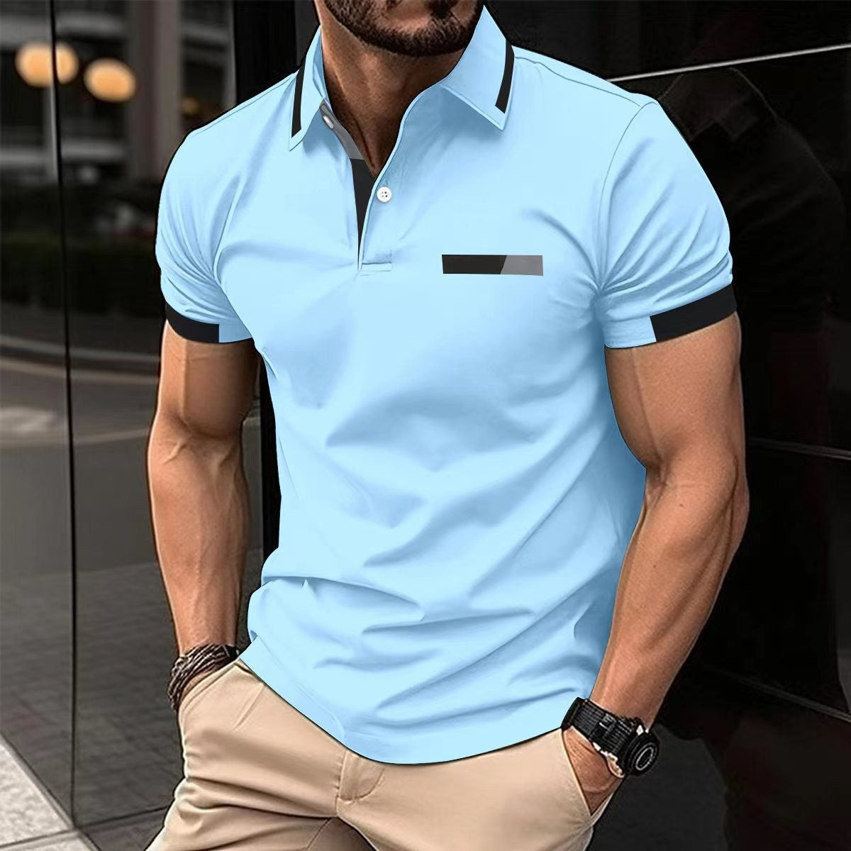 Man wearing a light blue polo shirt with black accents in an urban setting