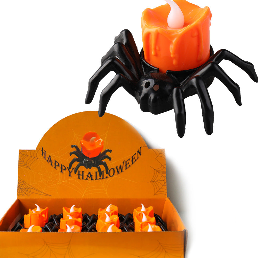 Spider-shaped candle with a lit candle inside, displayed in an open box with 'Happy Halloween' text.