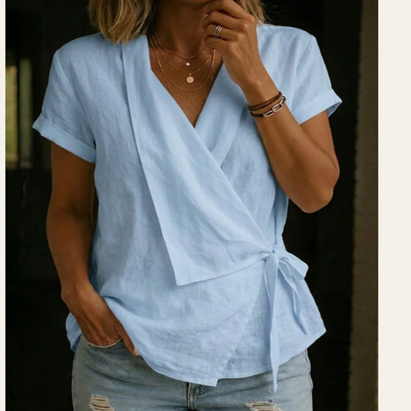 Light blue wrap top worn by a person with a blurred background