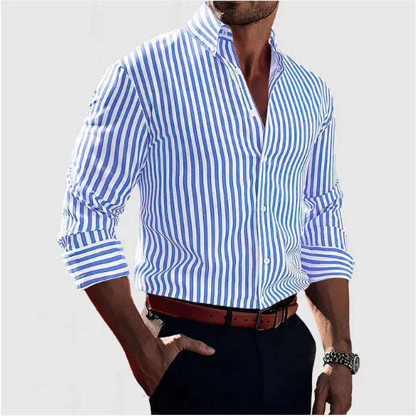 Man wearing a blue and white striped shirt with rolled-up sleeves on a light gray background