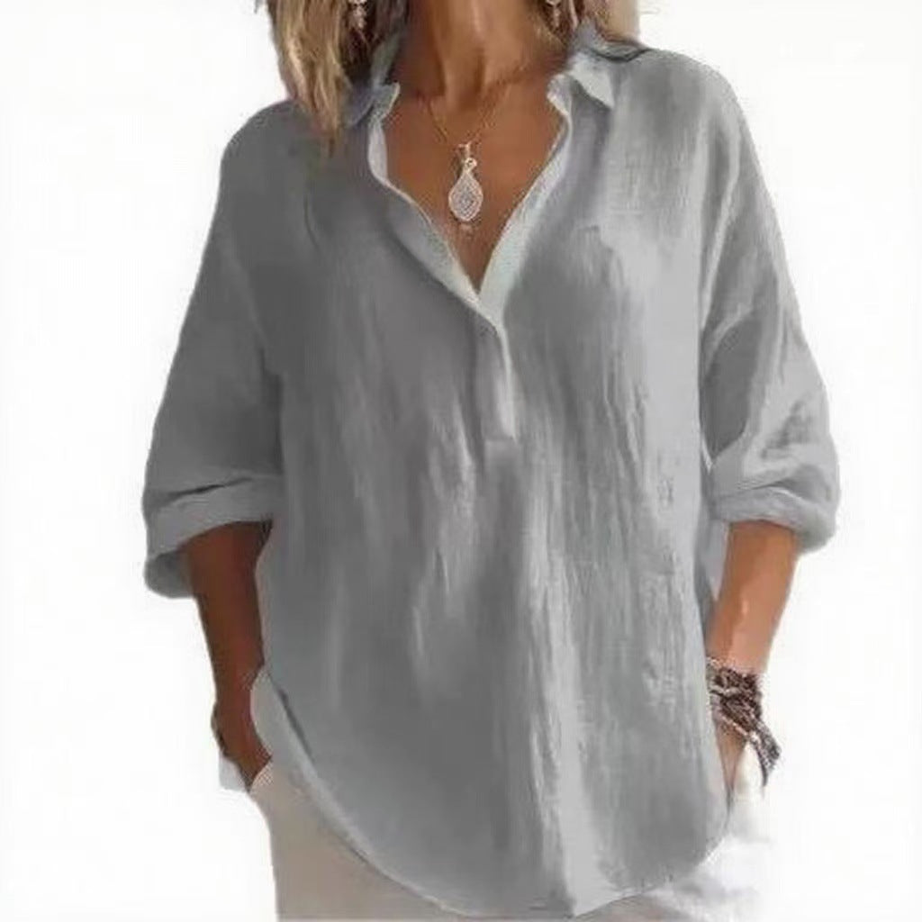 Gray blouse worn by a person on a white background