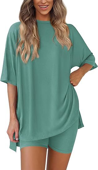 Woman wearing a green oversized t-shirt and shorts set on a white background