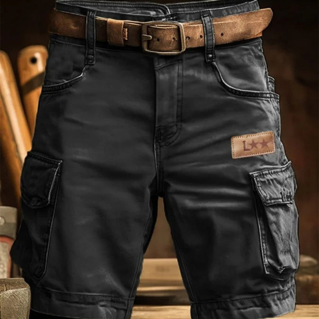 Black cargo pants with a brown belt and patch on a blurred background