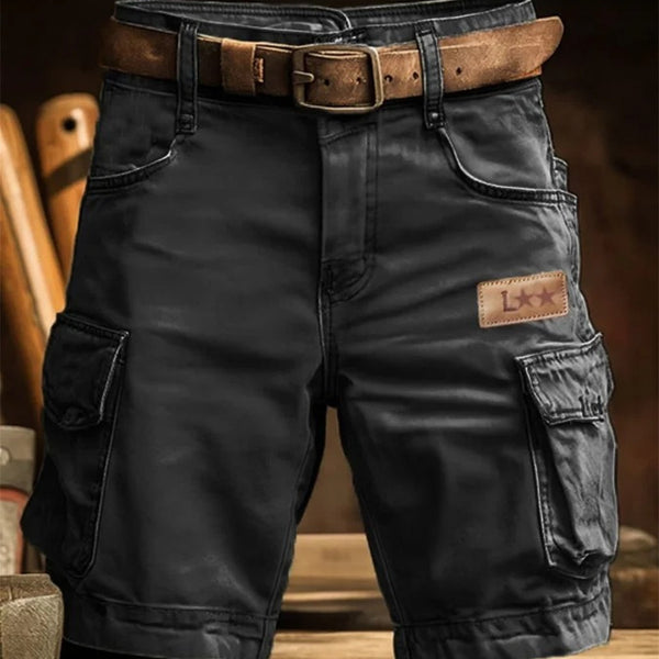 Black cargo pants with a brown belt and patch on a blurred background
