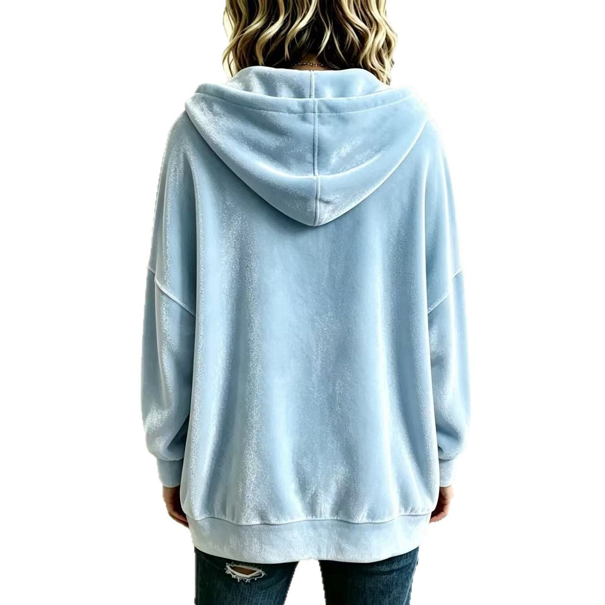A person shown from the back wearing an oversized light blue hooded sweatshirt and dark jeans against a plain white background.