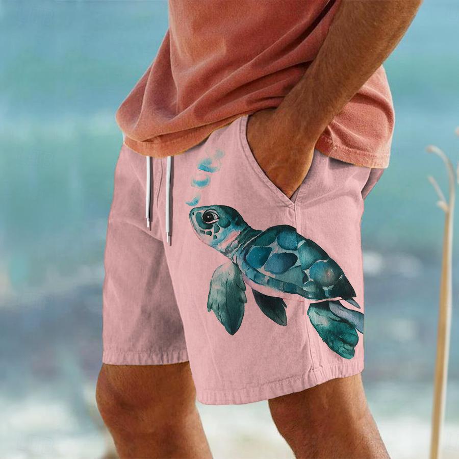 Person wearing pink shorts with a turtle design on a beach.