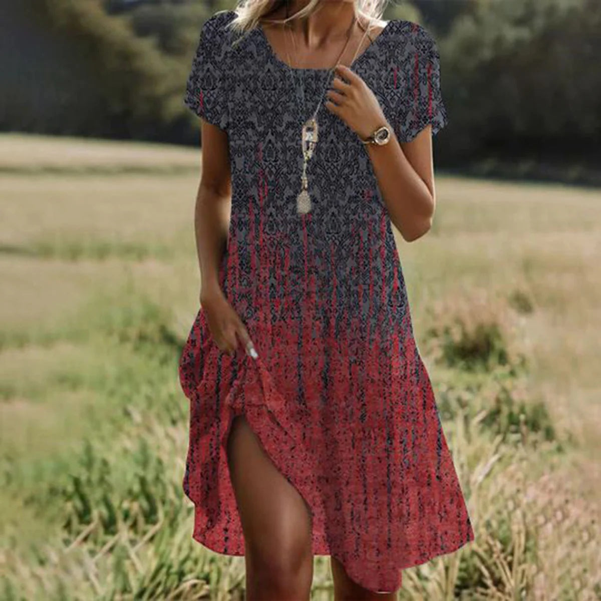 Woman wearing a patterned dress standing in a field