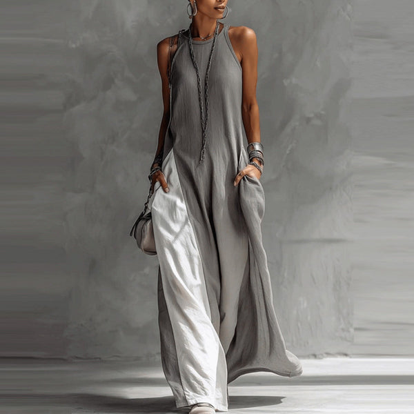 Woman wearing a gray sleeveless jumpsuit against a neutral background