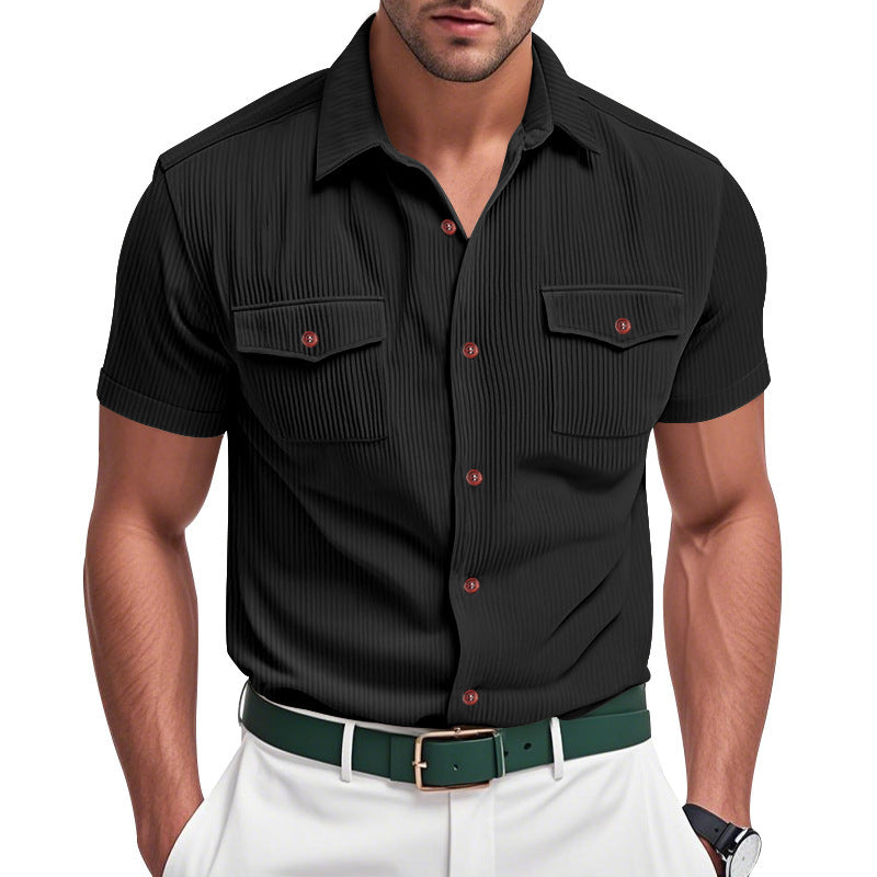 Man wearing a black short-sleeve shirt with red buttons and white pants on a white background