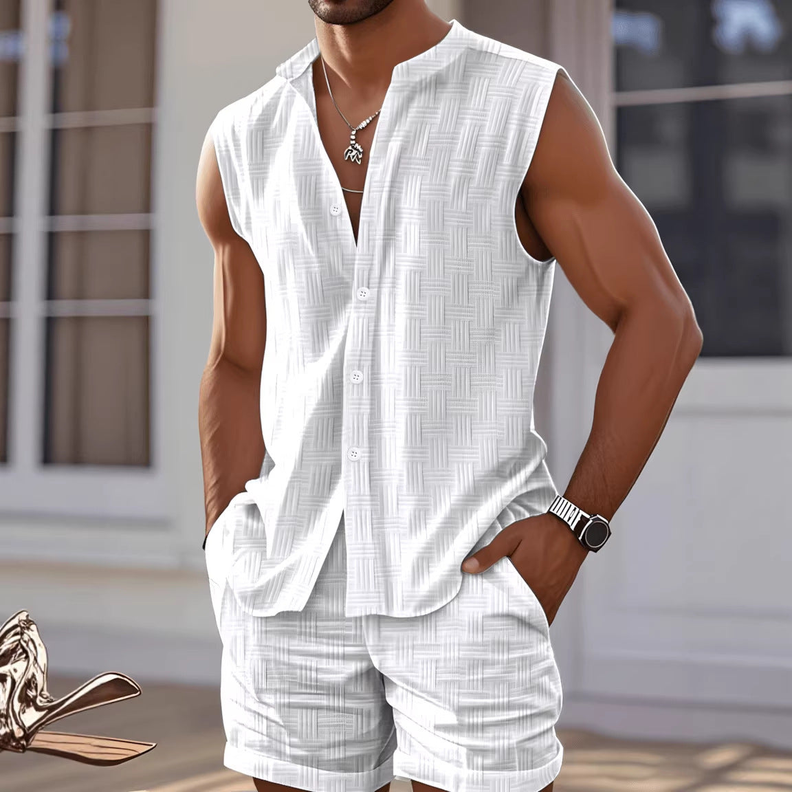 Man wearing a white sleeveless shirt and shorts set with a blurred background