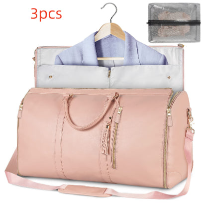 Pink duffel bag with clothes and organizer on a white background