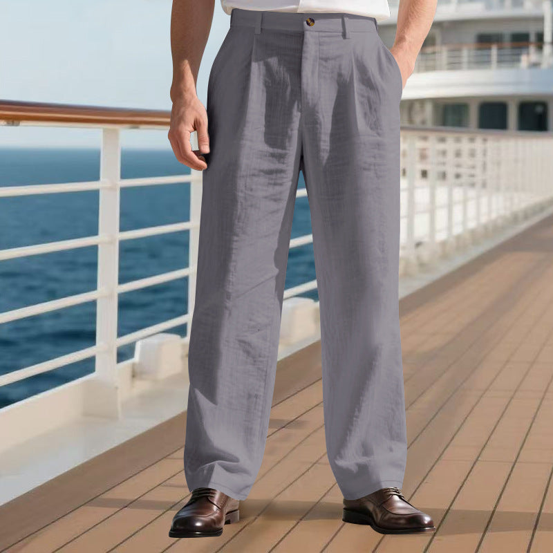 Person wearing gray pants standing on a cruise ship deck with ocean view