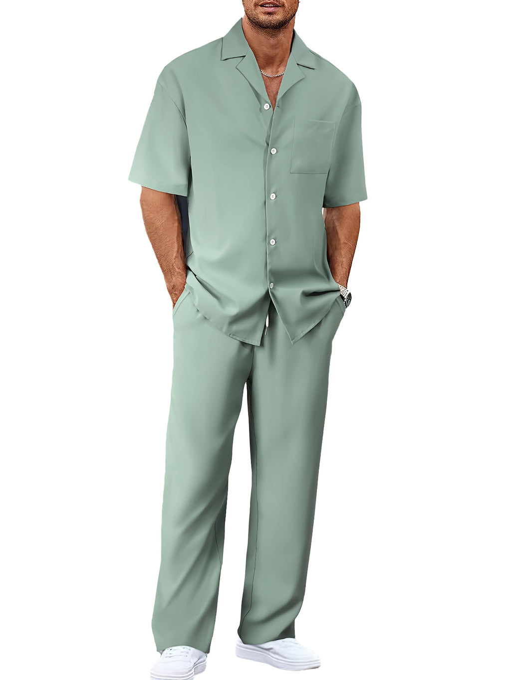 Man wearing a light green shirt and pants on a white background