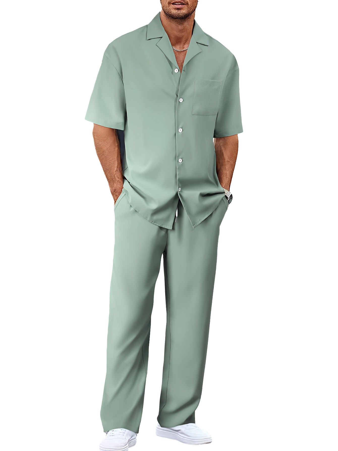 Man wearing a light green shirt and pants on a white background
