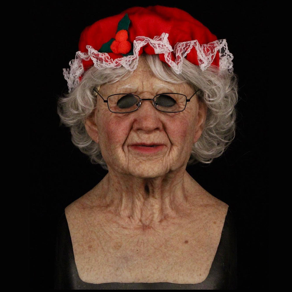 Bust of an elderly woman wearing a red hat with white lace trim on a black background