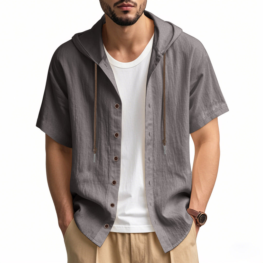 Man wearing a gray short-sleeve hooded shirt over a white t-shirt on a white background