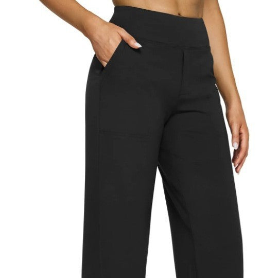 Black high-waisted pants worn by a person on a white background