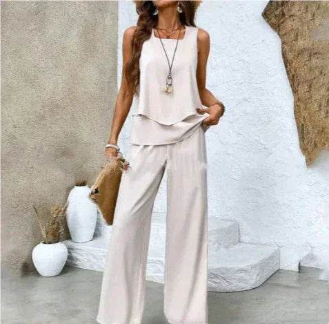 Woman in chic cream sleeveless top and wide-leg pants, accessorized, ZA-Zola fashion style