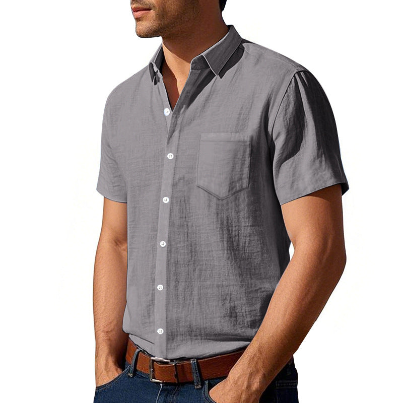 Man wearing a gray short-sleeve button-up shirt on a white background