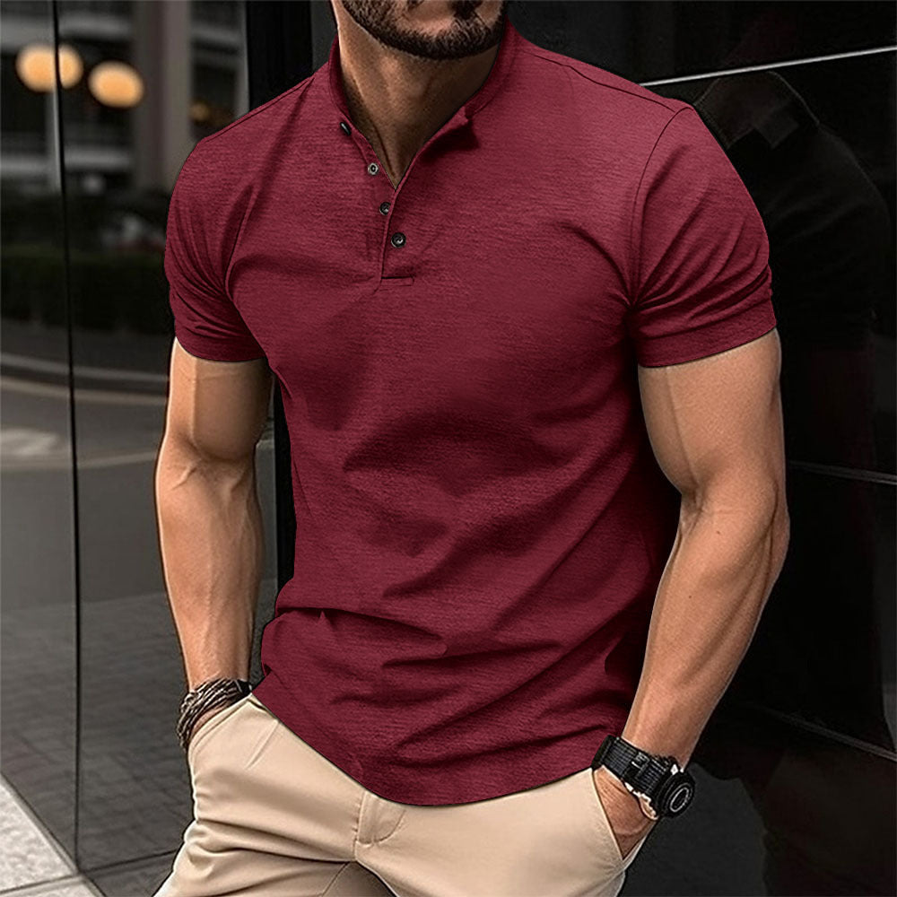 Man wearing a maroon polo shirt and beige pants in an urban setting