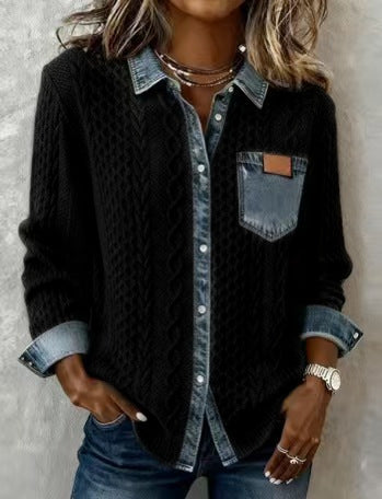 Person wearing a black textured shirt with denim collar and cuffs against a neutral background