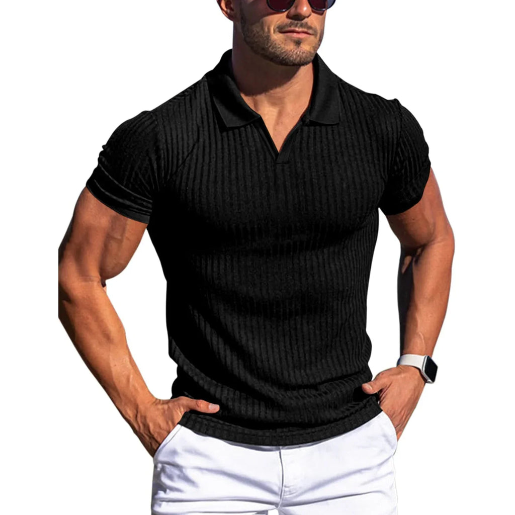 Man wearing a black ribbed polo shirt and white pants on a white background