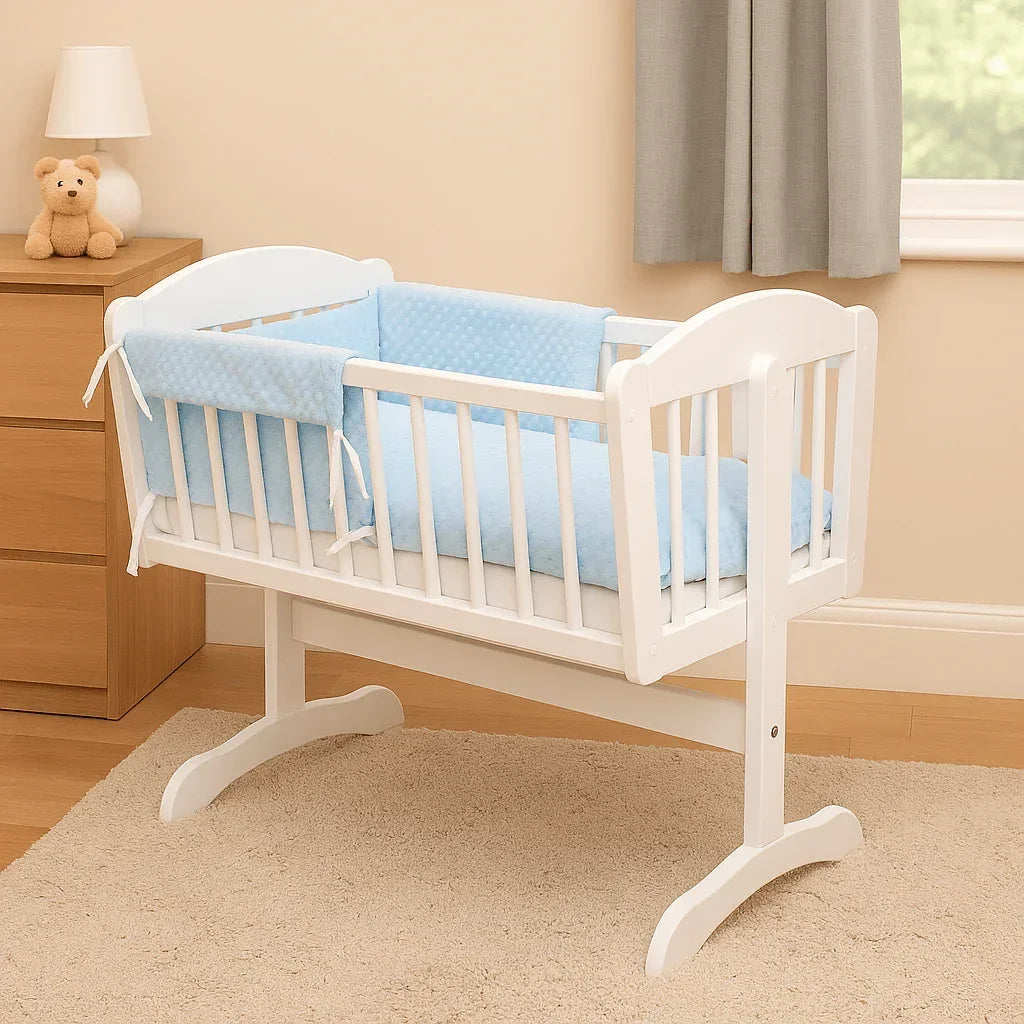 White wooden cradle with light blue dimple crib bedding set in a cozy nursery.