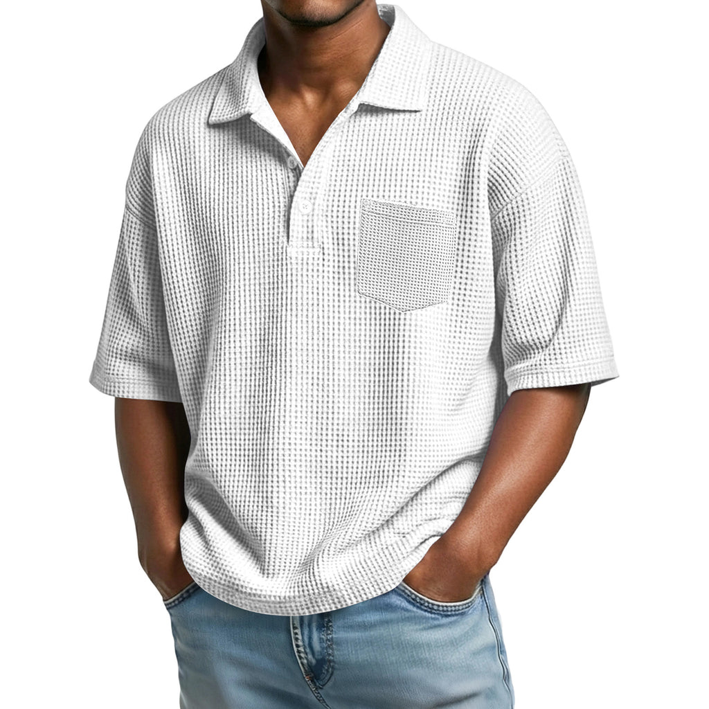 Man wearing a short-sleeve checkered shirt and jeans on a white background