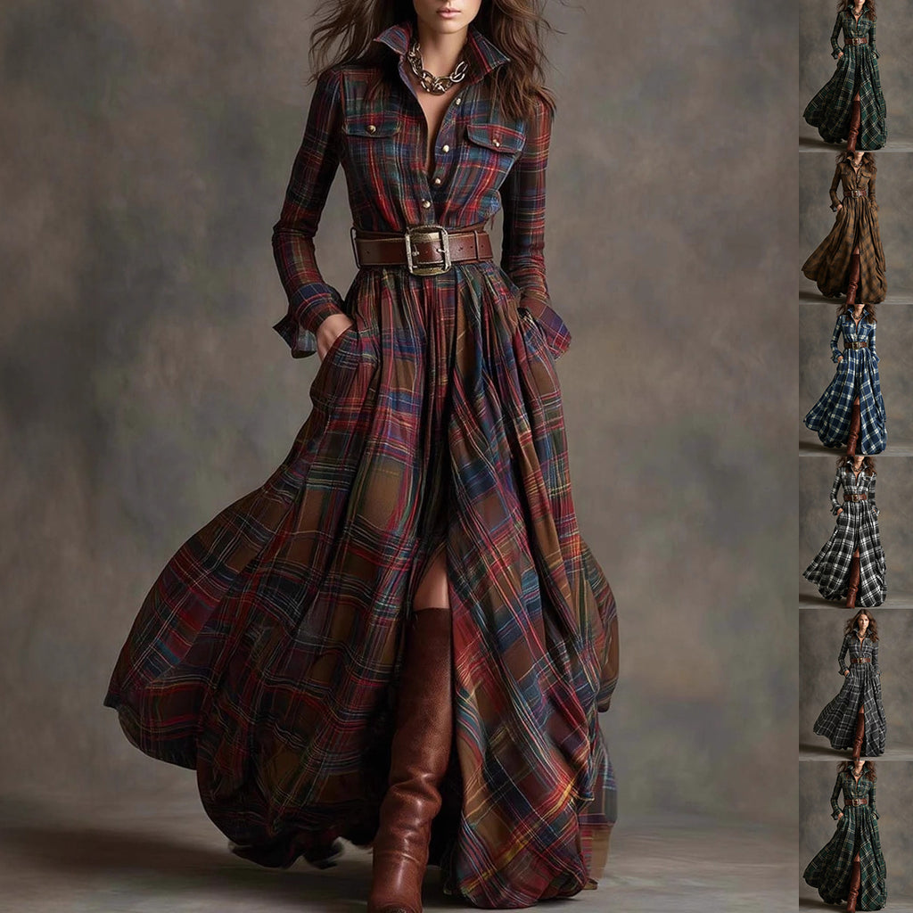 A woman models a long-sleeve plaid maxi shirt dress with a matching belt, standing against a textured gray studio backdrop. The dress features a multicolor tartan pattern with prominent red, blue, green, and brown tones.