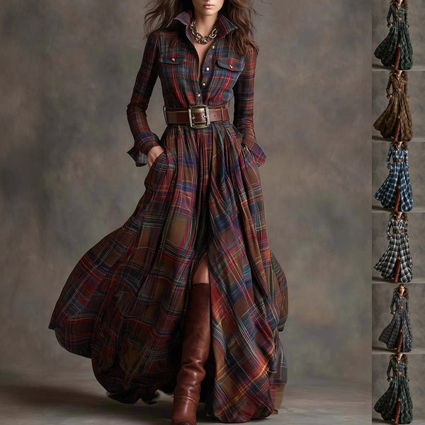 A woman models a long-sleeve plaid maxi shirt dress with a matching belt, standing against a textured gray studio backdrop. The dress features a multicolor tartan pattern with prominent red, blue, green, and brown tones.