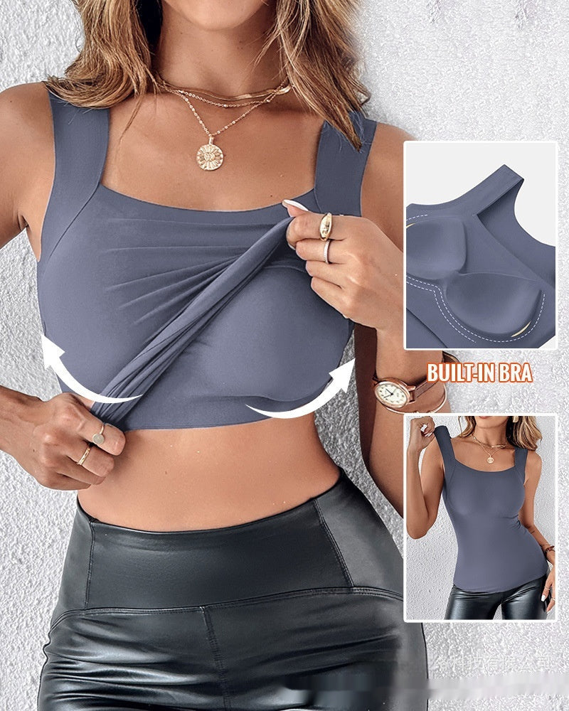 Woman wearing a gray sports bra with built-in bra feature, showing the design and functionality.