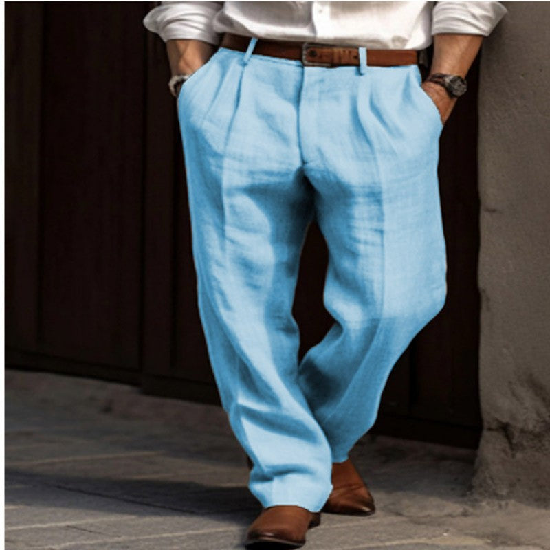 Person wearing light blue pants and a white shirt with a dark background