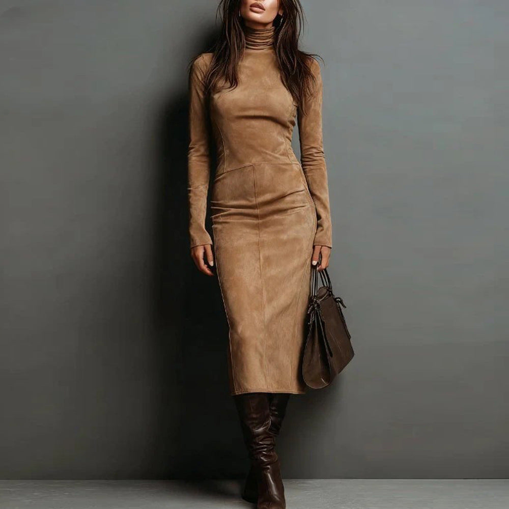 Woman wearing a brown suede dress and boots against a gray background