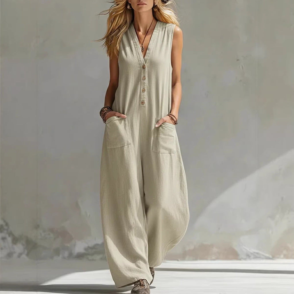 Woman wearing a beige sleeveless jumpsuit against a neutral background