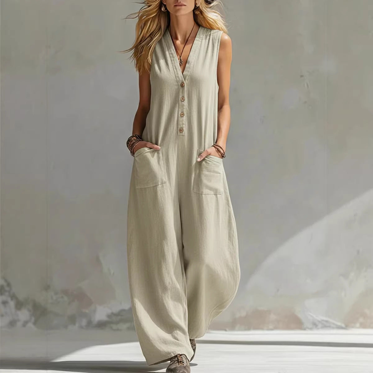 Woman wearing a beige sleeveless jumpsuit against a neutral background