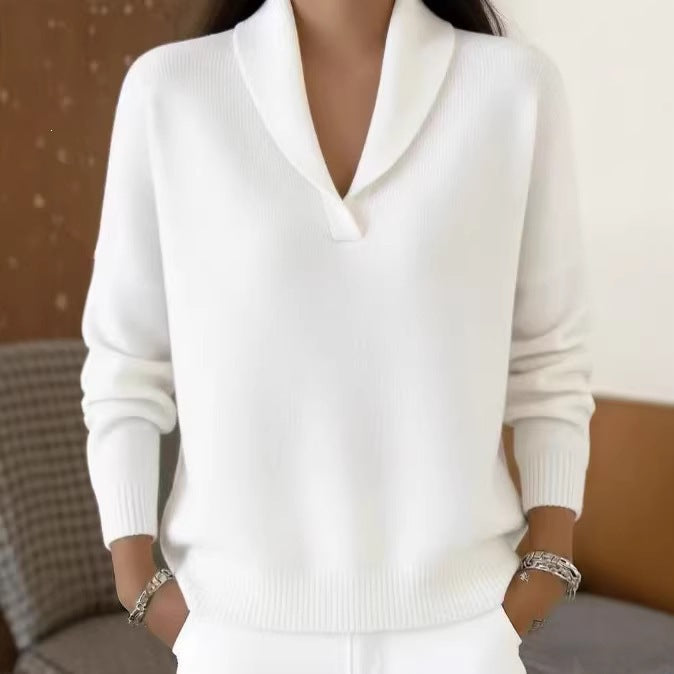 White sweater worn by a person with a blurred background