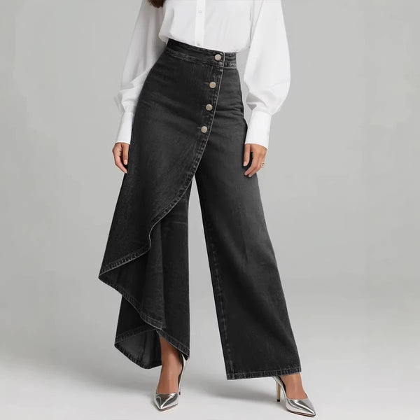 Person wearing a white blouse and black wide-leg pants with button details on a gray background