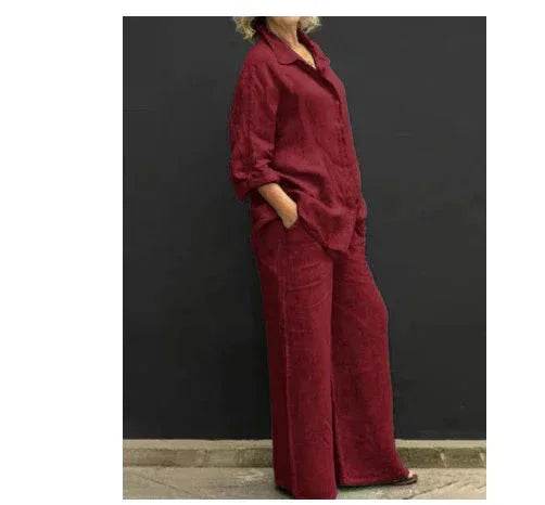 Woman models chic maroon pantsuit set against dark background at ZA-Zola UK fashion store