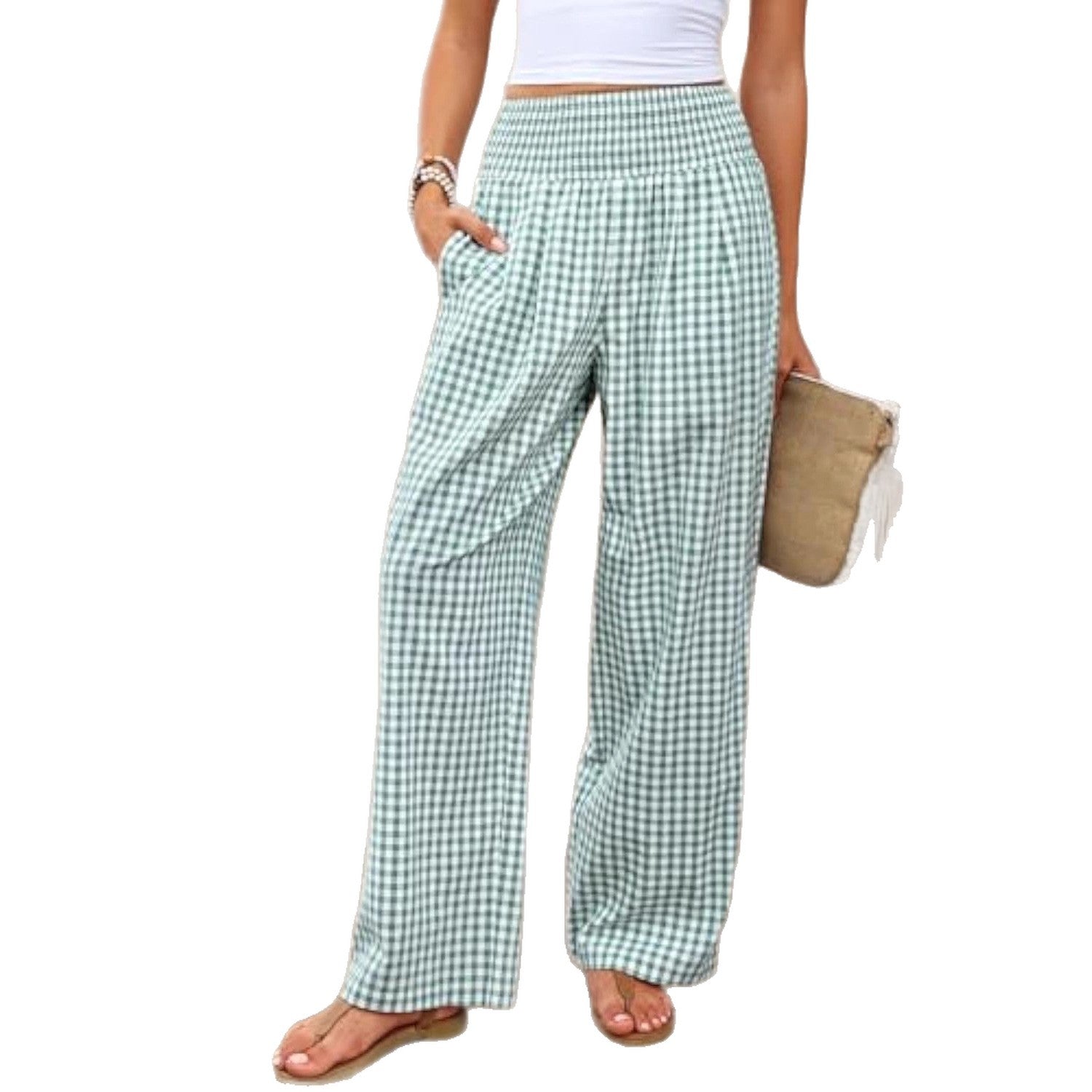 Green and white checkered pants worn by a person on a white background