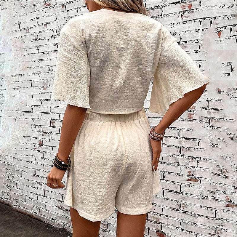 Woman wearing a cream textured short-sleeve romper, ZA-Zola chic summer fashion