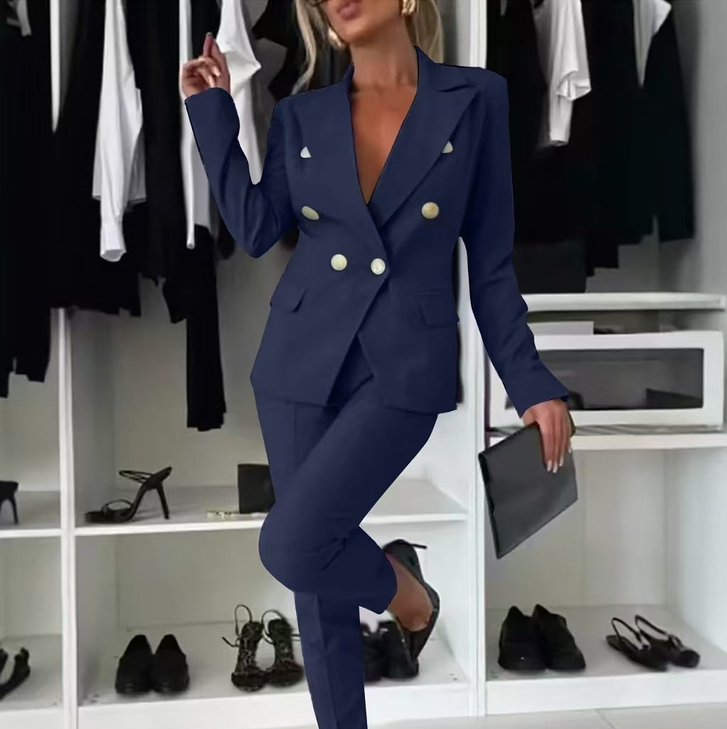 Woman in a navy blue suit standing in a closet with shoes and clothing around.