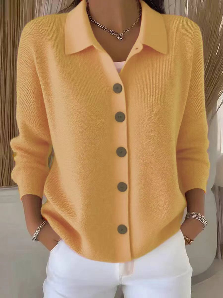 Yellow cardigan with buttons worn by a person, against a neutral background