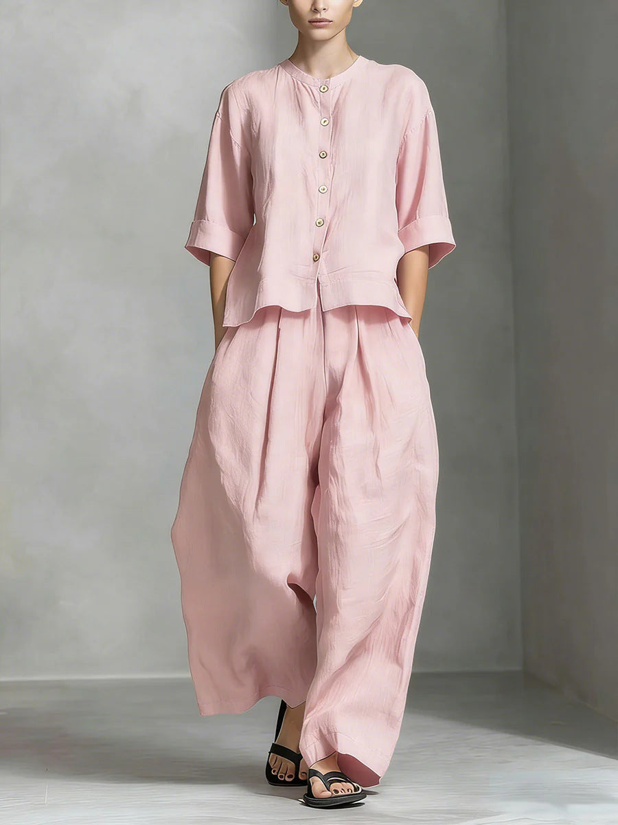 Person wearing a pink outfit against a gray background