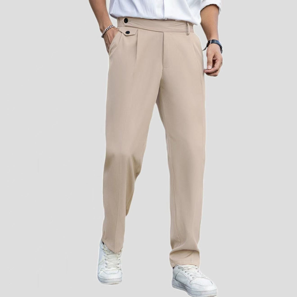 Beige pants worn by a person on a plain background