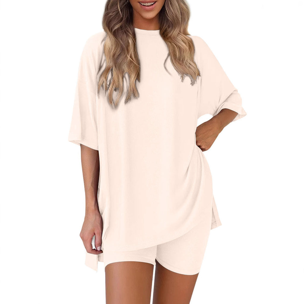 Woman wearing a beige oversized t-shirt on a white background
