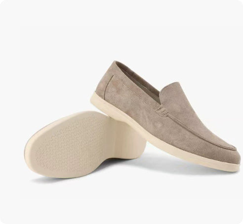 Pair of brown loafers on a white background