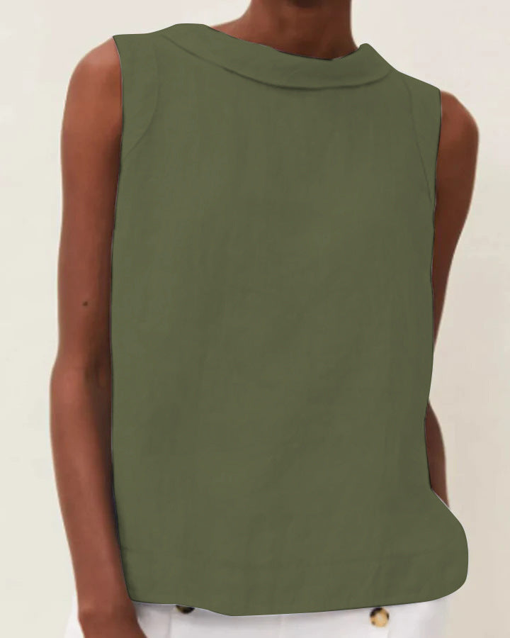 Green sleeveless top worn by a person on a beige background