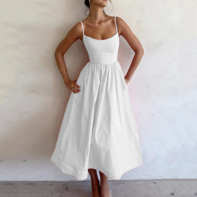 Woman wearing a white dress against a plain background