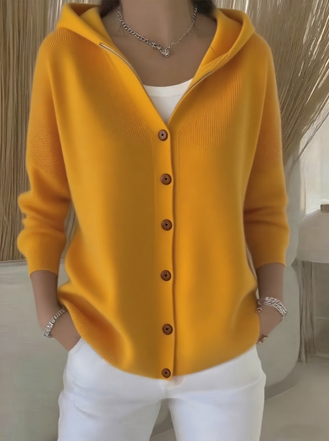 Yellow cardigan worn by a person with a neutral background