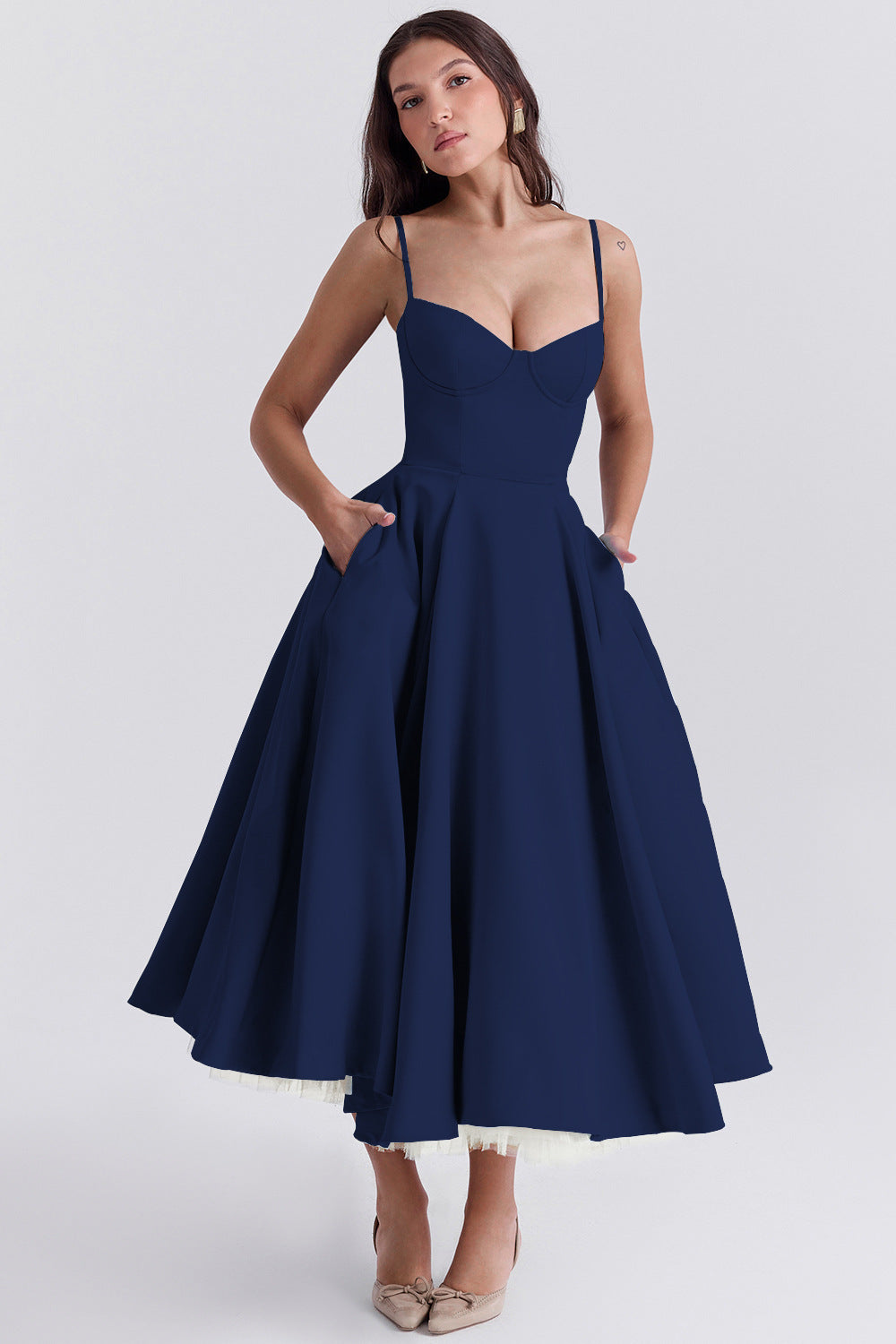 Woman wearing a navy blue dress on a white background